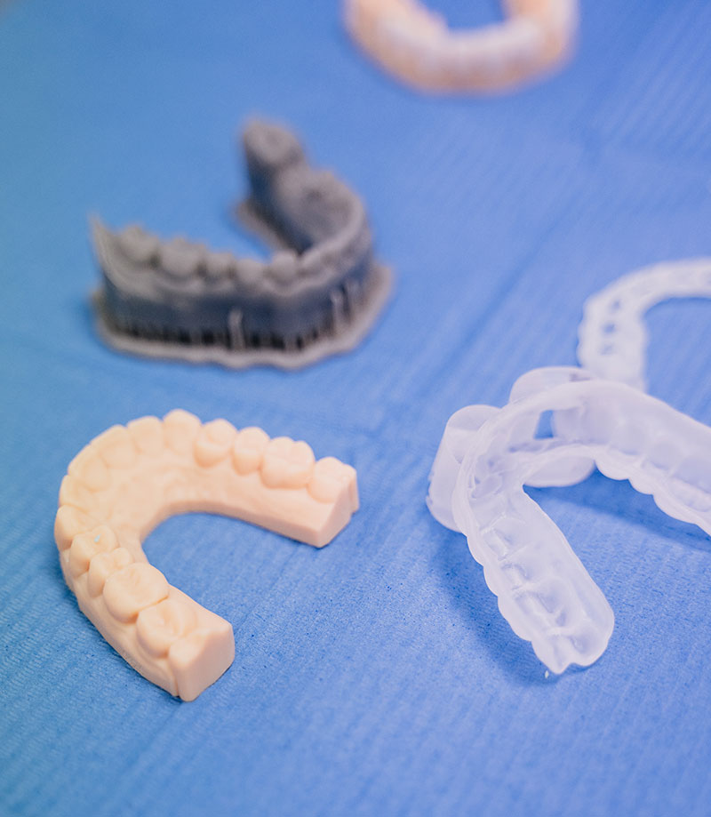 Varios moldes de dentadura de diferentes materiales para ortodoncia invisible